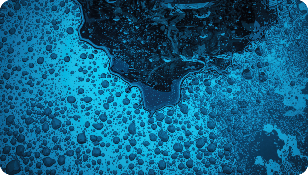 Aerial view of an oil sheen spreading across water, illustrating a refined fuel spill